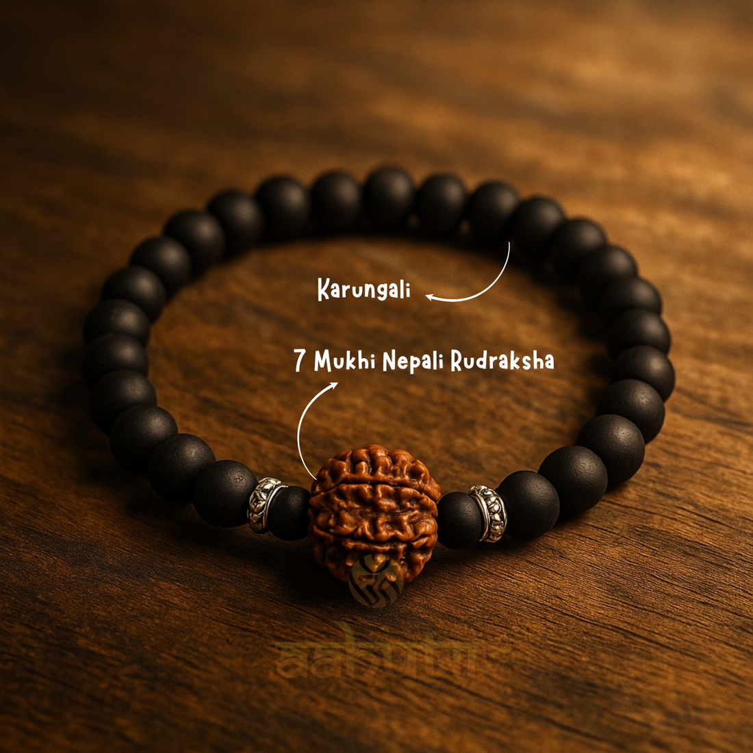 Black beaded bracelet with a Rudraksha bead on a wooden surface