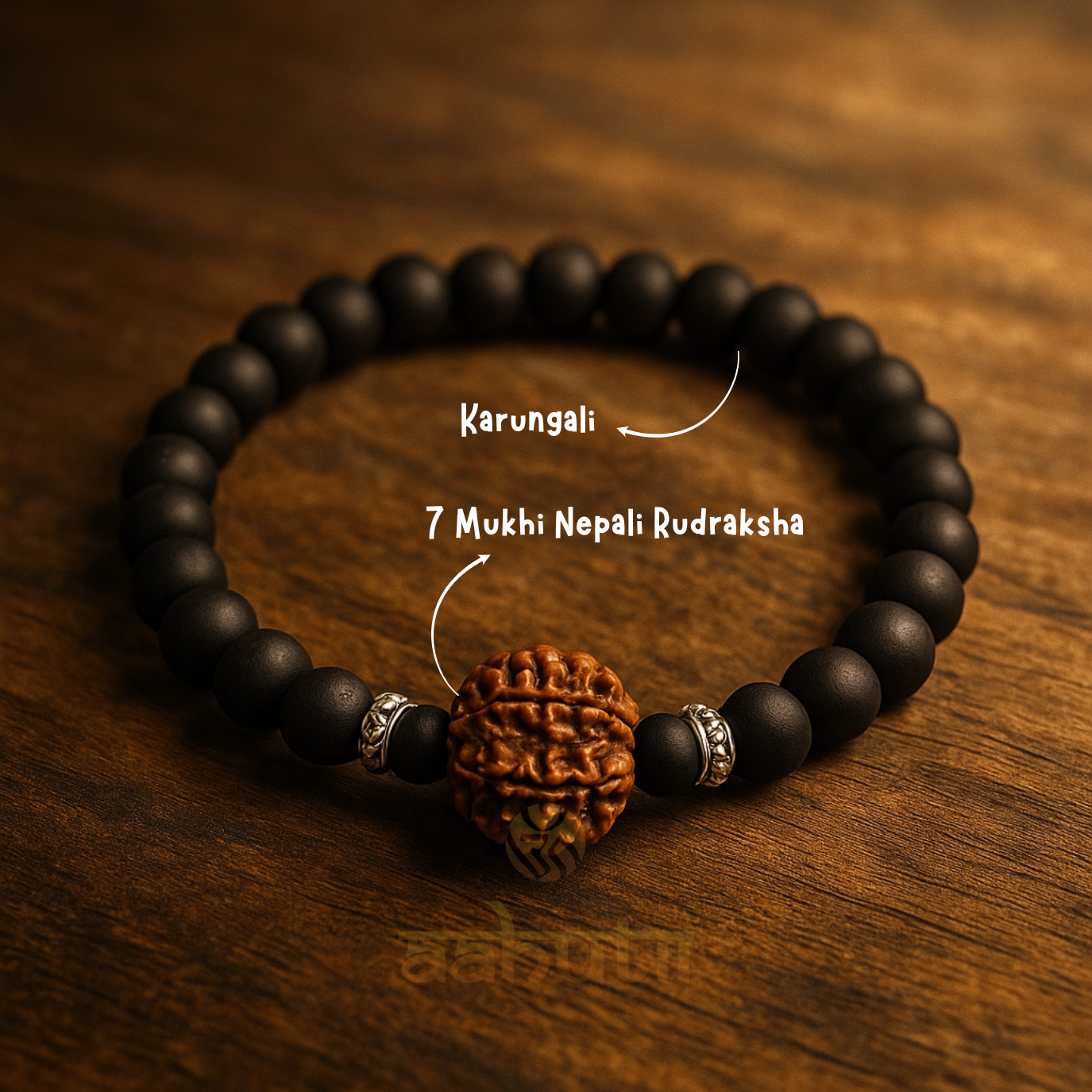 Black beaded bracelet with a Rudraksha bead on a wooden surface