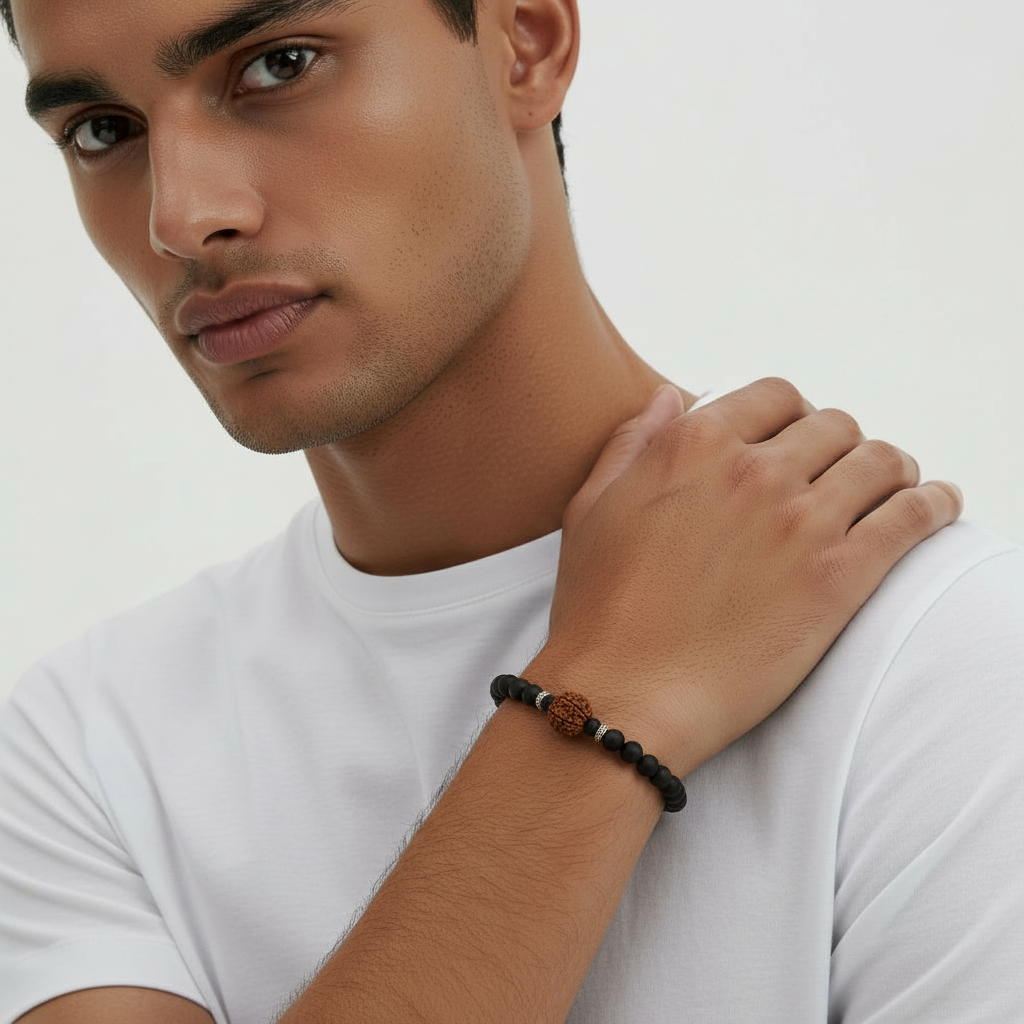 Man wearing a black beaded bracelet on a white background